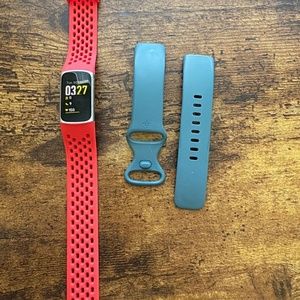 Fitbit charge 5 with blue and red straps